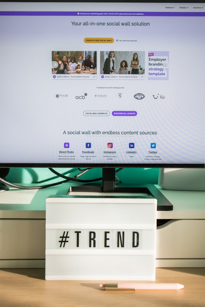 Vertical shot of a computer screen with a social media trend sign on a modern desk.